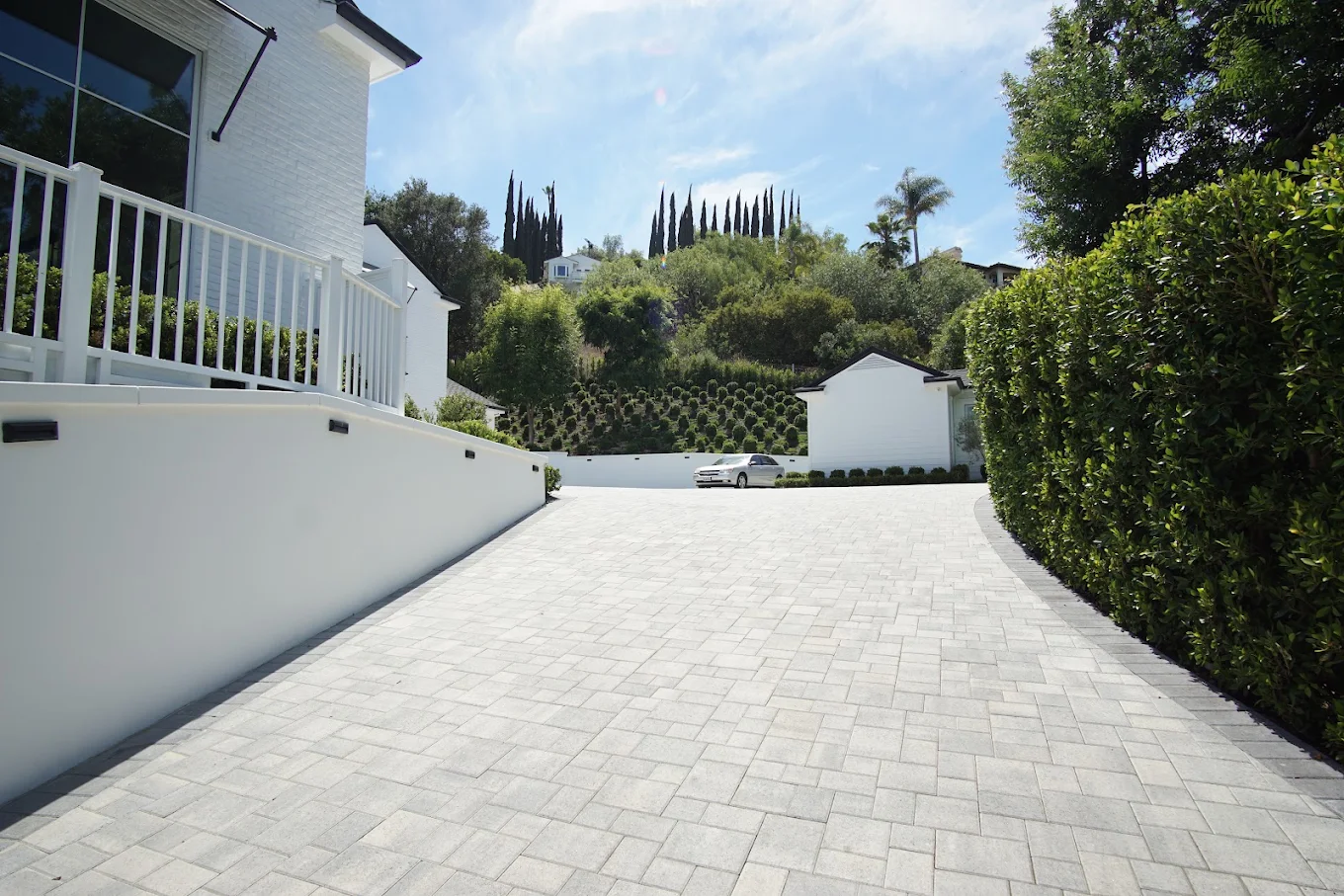 Paver driveway with a hedge-lined court in Carlsbad